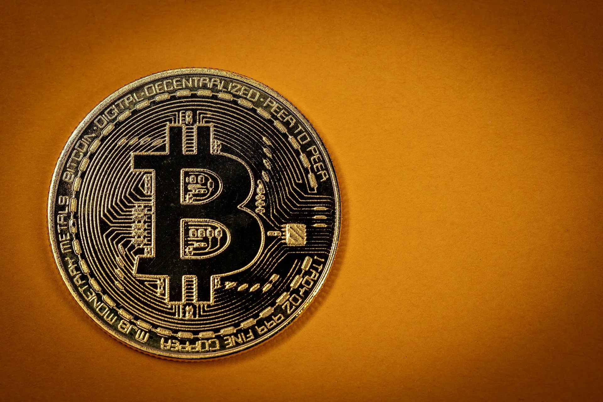 Bitcoin on orange background